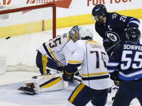 Blake Wheeler of the Jets scores the game-winning goal against Nashville Predators goalie Pekka Rinne during third period action in Winnipeg on Saturday night.