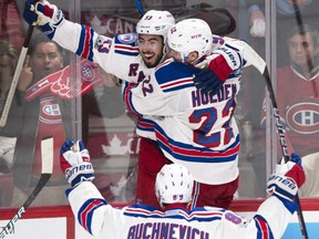 Mika Zibanejad celebrates with New York Rangers teammates Nick Holden and Pavel Buchnevich after scoring the game-winning goal in overtime during Game 5 of their first-round NHL playoff series against the Canadiens in Montreal on Thursday night.