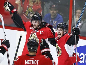 Senators captain Erik Karlsson celebrates his goal against the New York Rangers with teammates  Jean-Gabriel Pageau and Marc Methot during the third period of Game 1 of their second-round NHL playoff series in Ottawa on Thursday night.