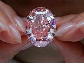 The Pink Star diamond, the most valuable cut diamond ever offered at auction, is displayed by a model at a Sotheby's auction room in Hong Kong. The diamond sold for $71.2 million, setting a record for any diamond or jewel.