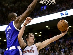 Toronto Raptors forward Serge Ibaka (9) fouls Miami Heat guard Goran Dragic (7) as he drives to the net during second half NBA basketball action, in Toronto on Friday, April 7, 2017.