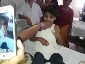 The young Indian "forest girl" sits on a bed at a hospital in this image taken from video in Bahraich northern India Thursday April 6, 2017.