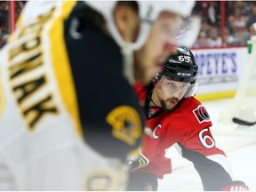 Erik Karlsson of the Ottawa Senators defends against David Pastrnak of the Boston Bruins on April 21.
