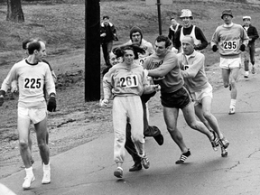 Jock Semple (in blazer and slacks) tries to remove Kathrine Switzer from the 1967 Boston Marathon.
