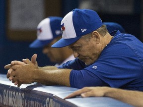 Manager John Gibbons hangs his head during the Blue Jays' 2017 home opener loss to Milwaukee on April 11.