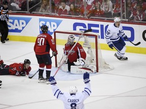 Toronto Maple Leafs' Kasperi Kapanen, right rear, celebrates his goal that beat Capitals netminder Braden Holtby while Toronto defenceman Connor Carrick raises his stick during the second overtime of Game 2 of their first-round playoff series in Washington on  Saturday night. The Leafs won 4-3.