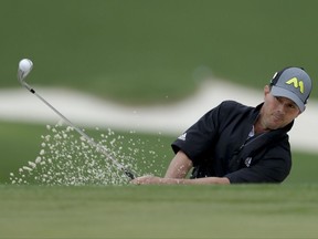 Mike Weir hits out of the bunker on the driving range during practice for the Masters on April 3.