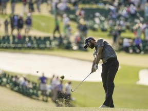Adam Hadwin plays a shot at the Masters on April 9.
