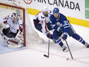 Toronto Maple Leafs' Auston Matthews tries to fend off the checking of Washingston Capitals' Daniel Winnick during Game 6 action in their East Conference quarter-final Sunday in Toronto. Covering the short side is goaltender Braden Holtby. The Caps won 2-1 in overtime to win the series in six games.