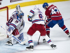 Alexander Radulov of the Montreal Canadiens bangs away to score the game-winning goal in overtime against New York Rangers' goaltender Henrik Lundqvist during Game 2 action Friday in their East Conference quarter-final in Montreal. Mike Zibanejad tries to defend against Radulov. The series is tied 1-1 heading into Game 3 Sunday in New York.