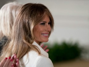 First lady Melania Trump smiles as she is recognized by President Donald Trump as he speaks at a women's empowerment panel, Wednesday, March 29, 2017, in the East Room of the White House in Washington.