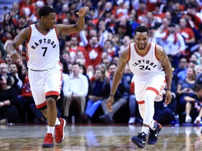 Norman Powell of the Toronto Raptors celebrates a dunk with Kyle Lowry in the second half of Game 5 of the Eastern Conference quarterfinals against the Milwaukee Bucks at the Air Canada Centre on April 24, 2017.