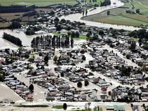 People used jet boats and tractors to help rescue about 2,000 residents after a river burst through a concrete levee Thursday in Edgecumbe, New Zealand.