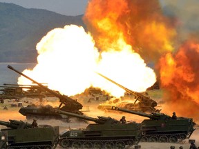 This photo released by North Korea shows the combined fire demonstration of the services of the Korean People's Army in celebration of its 85th founding anniversary at the airport of eastern front.