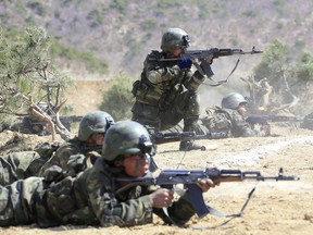 North Korean soldiers take part in a demonstration at an undisclosed location in North Korea.