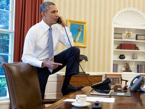 In this handout provided by the White House, U.S. President Barack Obama talks on the phone in the Oval Office of the White House August 31, 2013 in Washington, DC.