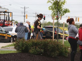 In this Wednesday, April 26, 2017 photo, police investigate at the scene after a Delaware state trooper was shot and killed in the parking lot of a WaWa convenience store near Bear, Del.