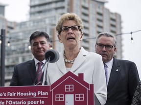 Ontario Premier Kathleen Wynne, centre, is joined by Ontario Finance Minister Charles Sousa, left, and Ontario Housing Minister Chris Ballard in Toronto on Thursday, April 20, 2017 to speak about Ontario's Fair Housing Plan.