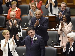 Ontario Finance Minister Charles Sousa, right, delivers the 2017 Ontario budget next to Premier Kathleen Wynne at Queen's Park in Toronto on Thursday, April 27, 2017.