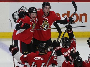 Ottawa Senators' Dion Phaneuf's celebrates his overtime winner against the Boston Bruins with teammate Mark Stone on Saturday at the Canadian Tire Centre.
