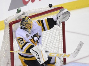 Pittsburgh Penguins goalie Marc-Andre Fleury reaches for the puck against the Washington Capitals on April 29.