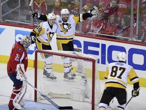 Phil Kessel (81) celebrates his goal against the Capitals' Philipp Grubauer with Penguins teammates Jake Guentzel and Sidney Crosby during the third period of Game 2 of their second-round playoff series on Saturday night in Washington.