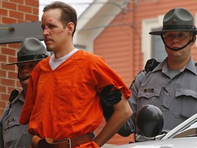 In this Oct. 31, 2014 file photo Eric Frein is escorted by police into the Pike County Courthouse for his arraignment in Milford, Pa