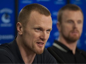 Daniel and Henrik Sedin speak to reporters at Rogers Arena on April 11.