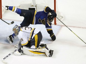 St. Louis Blues' Jaden Schwartz falls over Nashville Predators goalie Pekka Rinne  during the third period in Game 1 on Wednesday in St. Louis. The Predators won 4-3.