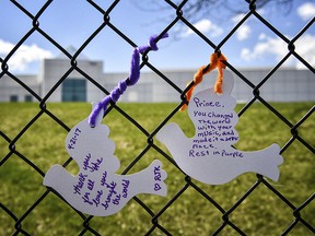 White paper doves on the fence outside Prince's Paisley Park on the first anniversary of his death Friday, April 21 2017, in Chanhassen, Minn.