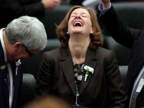 Alberta Premier Alison Redford shares a laugh with Deputy Premier Dave Hancock (left) and MLA Robin Campbell (right) following the Speech from the Throne at the Alberta Legislature, in Edmonton Alta., on Monday March 3, 2014.