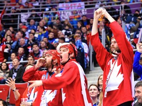 In this Feb. 19, 2014 file photo, Canadian fans cheer during a Sochi Olympic hockey quarterfinal against Latvia.