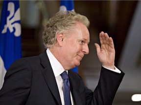 Quebec Liberal Party Leader Jean Charest waves goodbye after he announced his resignation at the Quebec legislature Wednesday, September 5, 2012.