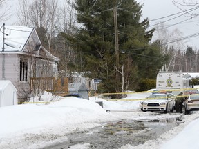 Police investigate a crime scene in Shawinigan, Que., on Thursday. Quebec provincial police say three women were killed early Thursday in separate incidents in Shawinigan.