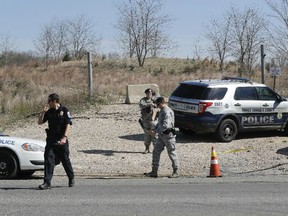 Law enforcement officer secure the area near the location where a military aircraft crashed, Wednesday, April 5, 2017, in Clinton, Md.