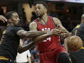 J.R. Smith, left, of the Cavaliers knocks the ball loose from Toronto Raptors' Norman Powell in the second half of their game Wednesday night in Cleveland. The Raptors won 98-83.