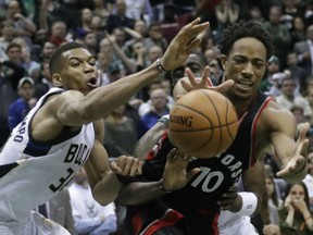 Giannis Antetokounmpo, left, of the Milwaukee Bucks battles DeMar DeRozan of the Toronto Raptors during Game 6 action in their East Conference quarter-final Thursday in Milwaukee. The Raptors won 92-89 to win the series 4-2 and advance against defending NBA champion Cleveland Cavaliers beginning Monday in Cleveland.