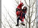 A woman is rescued from a downtown Toronto construction crane on Wednesday, April 26, 2017.