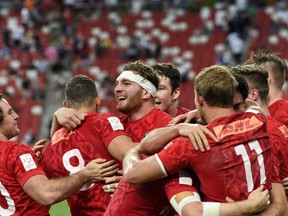 Canadian players celebrate winning the Singapore rugby sevens series tournament on April 16.