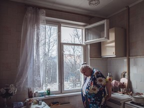 Tatyana Chaynikova, 68, stands in her apartment in a "khrushchevka" building in the Belyayevo district of Moscow.