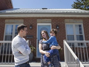 Sarah Blakely, husband Curtis and their son are pictured outside their three-bedroom home, in Toronto on Friday, April 14, 2017. They recently sold the house for more than $1 million and now expect to live mortgage-free in a four-bedroom purchase in their hometown of Ottawa.