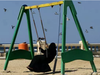 A Saudi veiled woman enjoys a swing in a park during holiday in Jiddah, Saudi Arabia. A young Saudi woman's plea for help after she was stopped in an airport in the Philippines en route to Australia where she planned to seek asylum has triggered a firestorm on social media and drawn attention to the plight of Saudi females fleeing repressive male relatives.