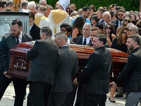 Mourners carry the casket of Karina Vetrano from St. Helen's Church following her funeral in Queens, New York.