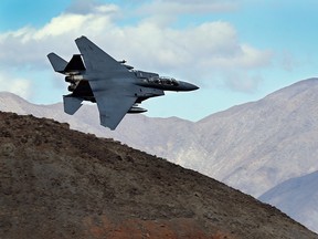 In this Feb. 27, 2017, photo an F-15E Strike Eagle from Seymour Johnson AFB in North Carolina flies out of the nicknamed Star Wars Canyon turning toward the Panamint range over Death Valley National Park, Calif.
