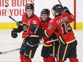 Calgary Flames forwards Sean Monahan, Johnny Gaudreau and Matthew Tkachuk celebrate a Monahan goal against the San Jose Sharks on March 31.