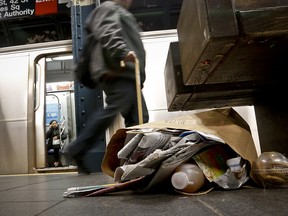 Garbage collects near a set of benches on a subway platform, Thursday March 30, 2017, in New York. Faced with the problem of too much litter and too many rats in their subway stations, New York City transit officials began an unusual social experiment a few years ago. They removed trash bins entirely from select stations, figuring it would deter people from bringing garbage into the subway in the first place. This week, they pulled the plug on the program after reluctantly concluding that it was a failure.