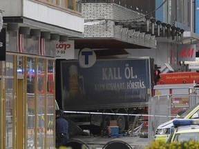 The rear of a truck, left, protrudes after it crashed into a department store injuring several people in central Stockholm, Sweden, Friday April 7, 2017.