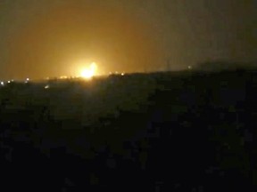 This frame grab from video provided by the Syrian anti-government activist group Ghouta Media Center shows flames rising after an explosion near an airport west of Damascus, Syria, Thursday, April 27, 2017.