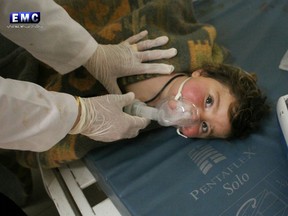 This photo provided Tuesday, April 4, 2017 by the Syrian anti-government activist group Edlib Media Center, shows a Syrian doctor treating a child following a suspected chemical attack.