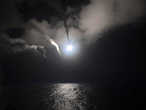 In this file image provided on Friday, April 7, 2017 by the U.S. Navy, the guided-missile destroyer USS Porter (DDG 78) launches a tomahawk land attack missile in the Mediterranean Sea.